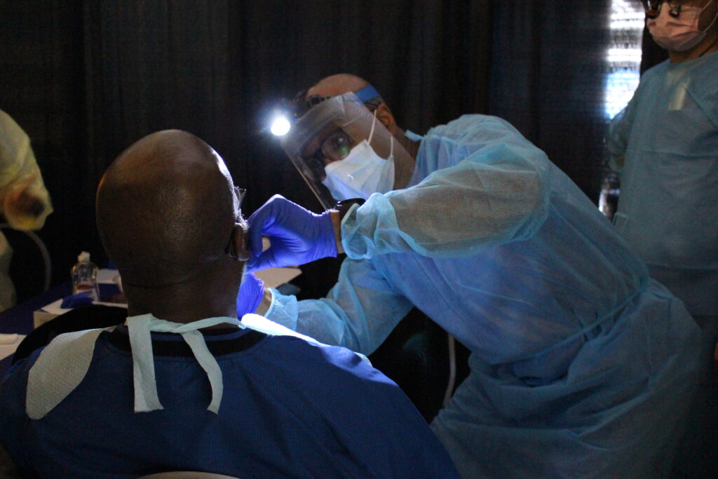 Dentist performing oral screening
