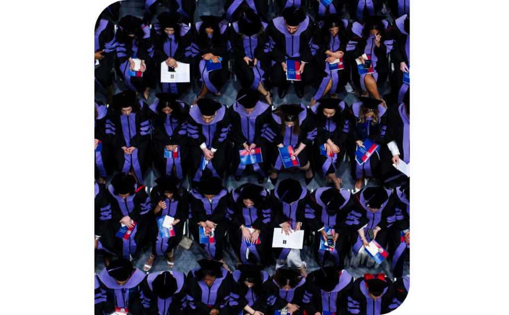 Aerial view of the University of Detroit Mercy Dental Class of 2025 graduates seated in caps and gowns inside Calihan Hall during the commencement ceremony.